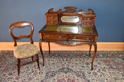 Lot 6587 - An Edwardian carved mahogany writing table...
