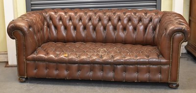 Lot 6 - A brown button upholstered leather...