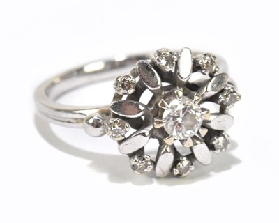 Lot 1101 - A white metal diamond set floral dress ring,...