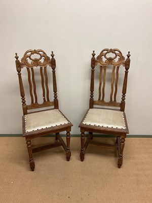 Lot 560 - Two oak upholstered hall chairs.