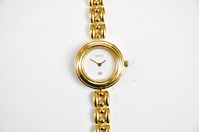 Lot 610 - GUCCI; a ladies gold-plated wristwatch,...