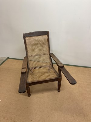 Lot 459 - A planters chair with hinged arms and caned...