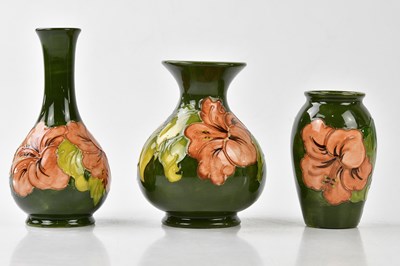 Lot 1223 - MOORCROFT; three vases decorated in the 'Coral...