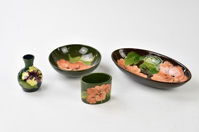 Lot 1225 - MOORCROFT; four pieces decorated in the 'Coral...