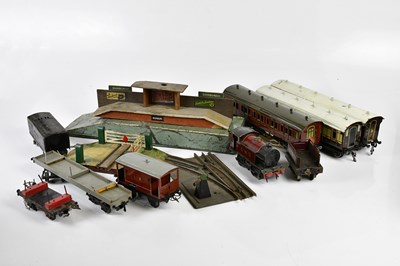 Lot 4349 - A collection of tin plate model railway items,...