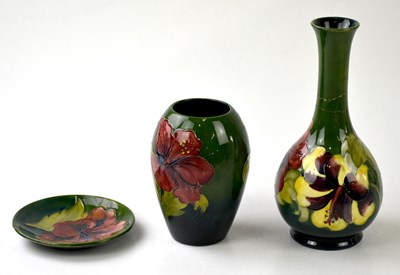 Lot 1220 - MOORCROFT; three pieces in the 'Hibiscus'...