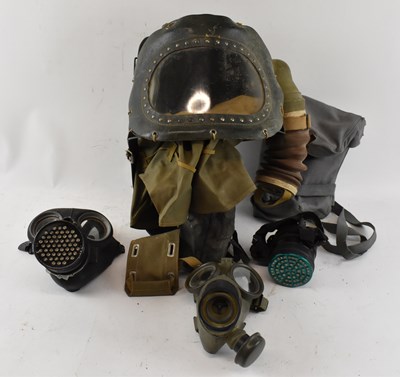 Lot 374 - A group of three WWII gas masks and a baby's...