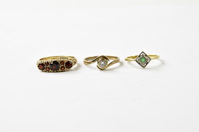 Lot 1139 - An 18k yellow gold dress ring with green stone,...