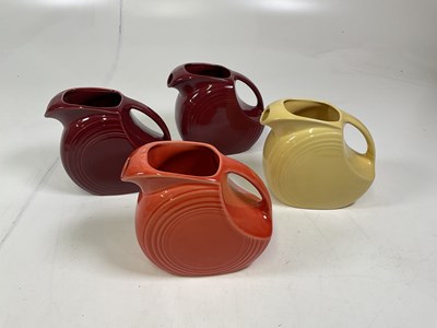Lot 211 - Four Fiesta style jugs, height 19cm.