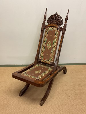 Lot 489 - An inlaid hardwood folding chair with leather...