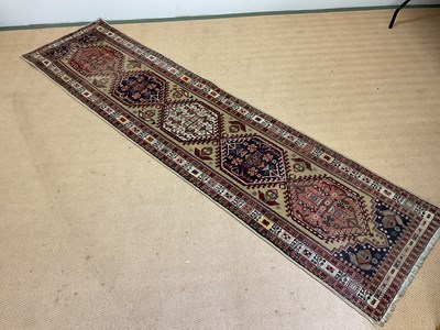 Lot 421 - A Persian runner with central medallions and a...