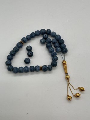 Lot 316 - A blue stained coral and yellow metal mounted...