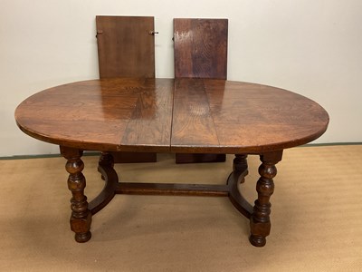 Lot 457 - An oak dining table with two leaves, height...