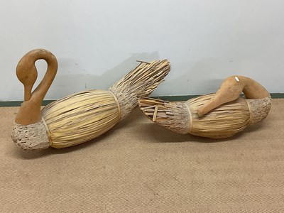 Lot 438 - A pair of thatched and carved wooden swans,...