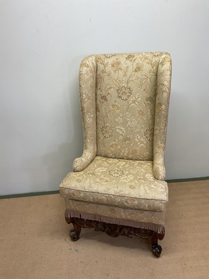 Lot 512 - A high wingback chair, height 132cm.