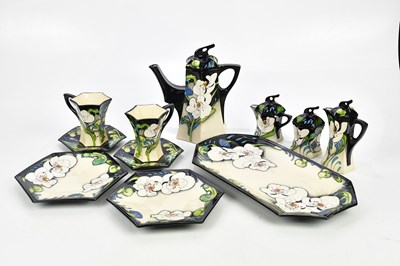 Lot 2248 - MOORCROFT; a rare and unusual 'Au Lait' eleven...