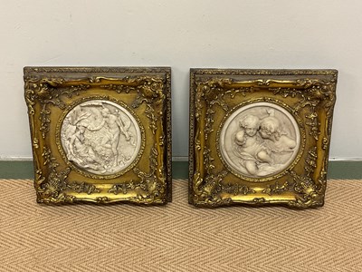 Lot 242 - A pair of reproduction circular plaques,...