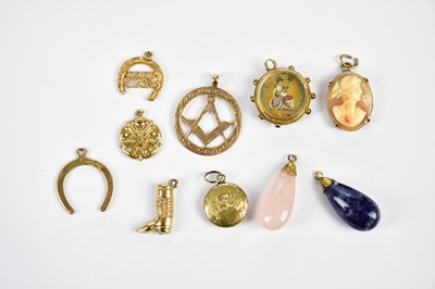 Lot 6 - A 9ct gold Masonic charm, two 9ct horse shoe...