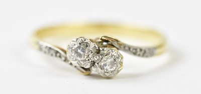 Lot 1156 - An 18ct diamond illusion set cross over ring,...