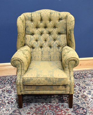 Lot 45 - A reproduction wing back armchair on square...