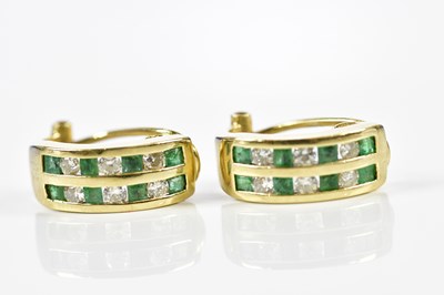 Lot 465 - A pair of yellow metal emerald and diamond...