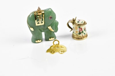 Lot 22 - A Chinese inspired carved green stone pendant...