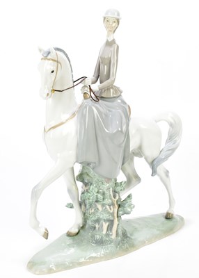 Lot 1237 - LLADRÓ; a large figure of a lady riding side...
