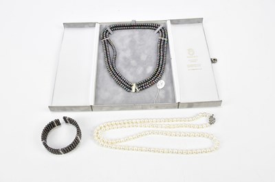 Lot 1145 - A three strand black pearl necklace and...