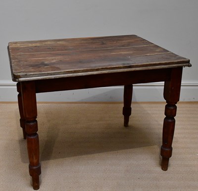 Lot 1199 - An old stained pine kitchen table, length 100cm.