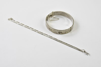 Lot 566 - A hallmarked silver hinged oval snap bangle...