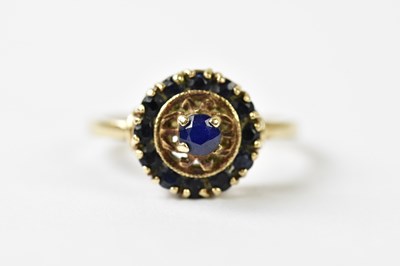 Lot 1138 - A 9ct yellow gold dress ring set with blue...