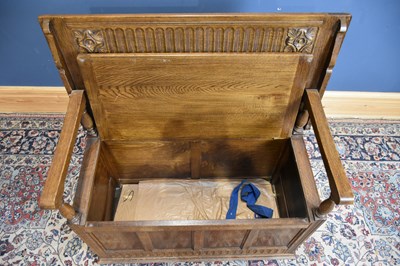 Lot 14 - A 1950s oak monk's bench with panelled front,...