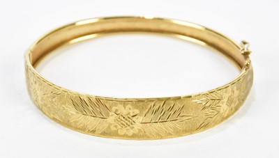 Lot 1128 - A yellow metal snap bangle stamped 375, approx...