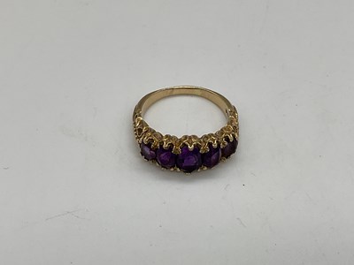 Lot 345 - A 9ct yellow gold amethyst five stone dress...