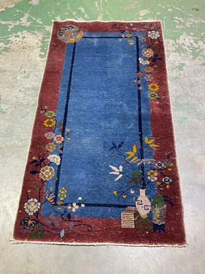 Lot 430 - An Oriental style rug featuring blossom and...
