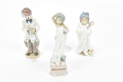 Lot 1244 - LLADRÓ; three boxed figures and a model...