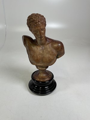 Lot 187 - A bust of Hermes mounted on a black glass base,...