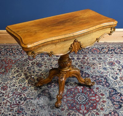 Lot 25 - A Victorian walnut serpentine card table with...