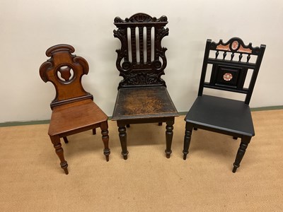 Lot 550 - Three chairs with carved decoration, one oak,...