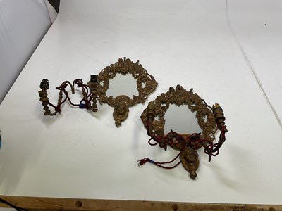 Lot 396 - A pair of brass wall mirror lights depicting...