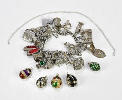 Lot 564 - A hallmarked silver charm bracelet with white...