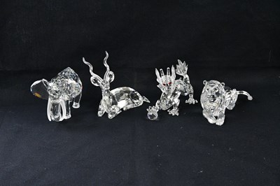 Lot 1366 - SWAROVSKI; four crystal figures including lion...