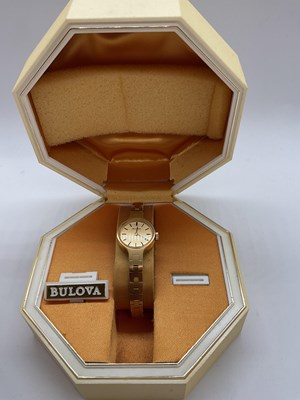 Lot 387 - BULOVA; a lady's gold plated wristwatch in...