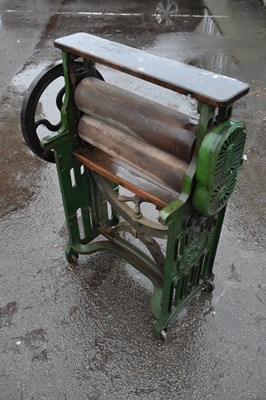 Lot 1238 - TAYWIL; a cast iron and wooden green painted...