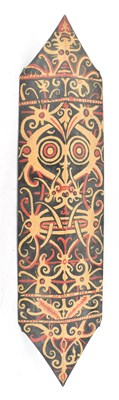 Lot 556 - A tribal shield with black and red painted...