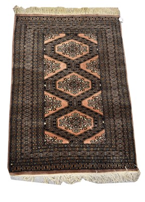 Lot 82 - A Pakistani hand knotted black ground rug, 79...