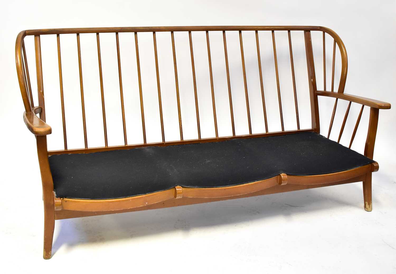 Lot 7 - ERCOL; an elm stick back three-seater settee...