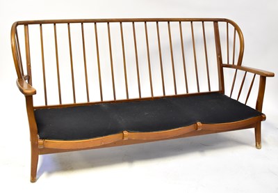 Lot 31 - ERCOL; an elm stick back three-seater settee...