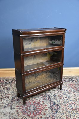 Lot 25 - GLOBE WERNICKE; a metal bound oak three tier...