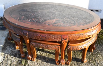 Lot 33 - A modern carved Chinese style nest of coffee...